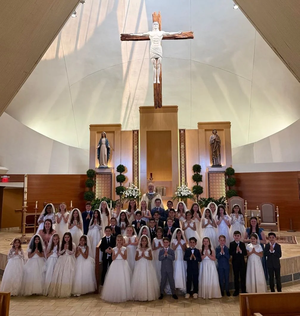 First Communion class in front of the altar at St. Regis Church
