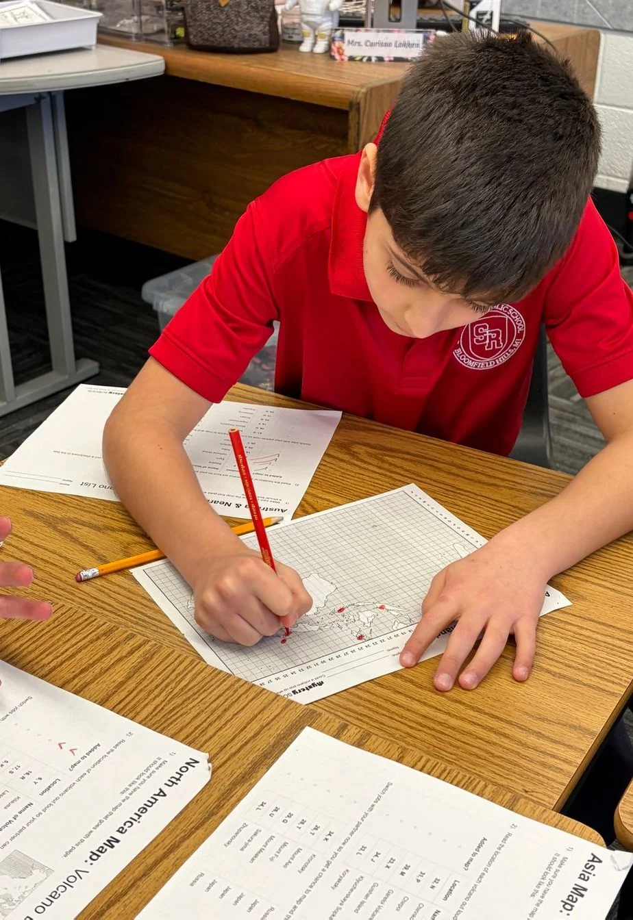 Student writing at his desk