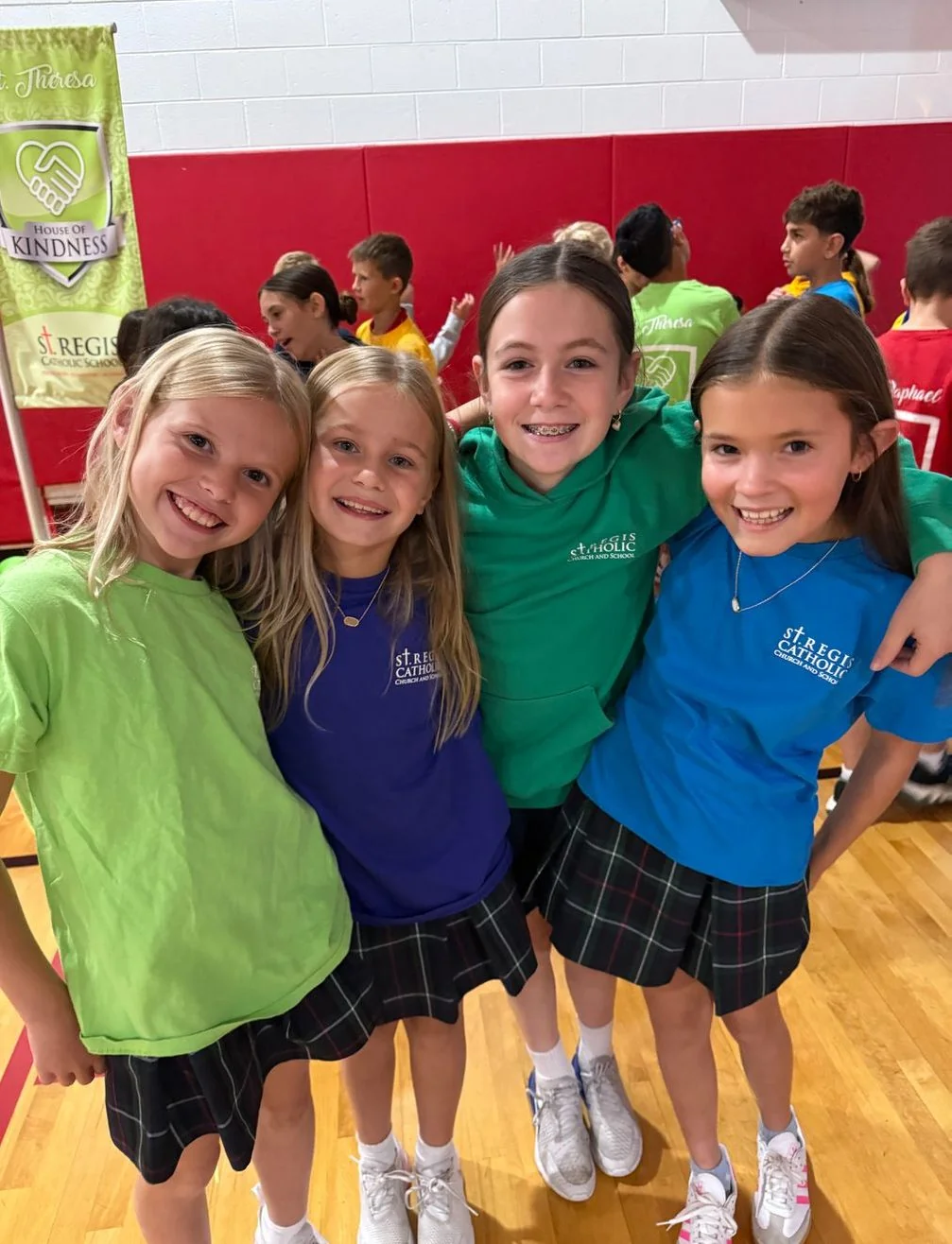Students in house T-shirts in the gym