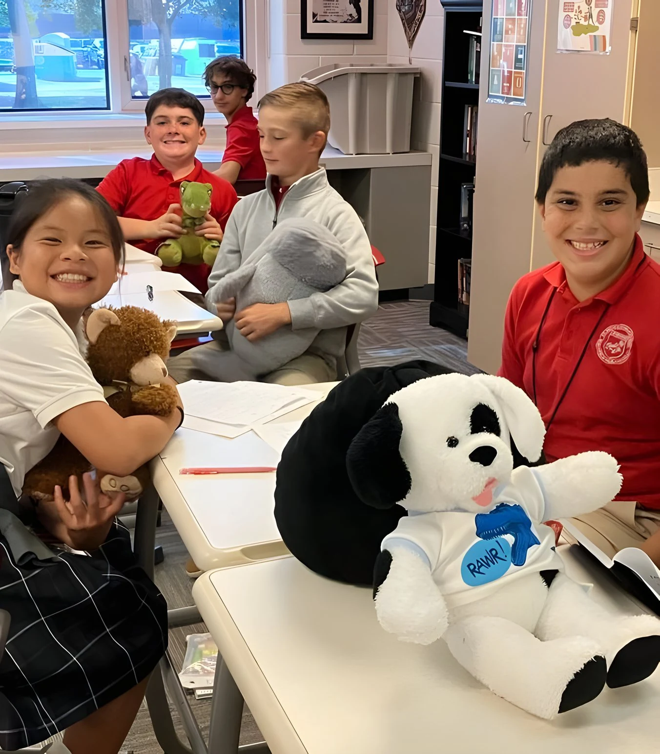 Students in class with stuffed animals