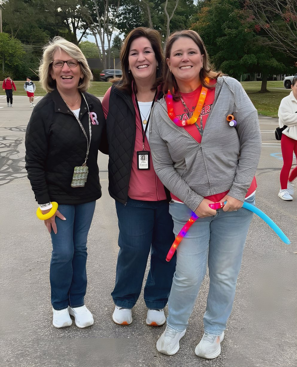 Three St. Regis staff members at a school event