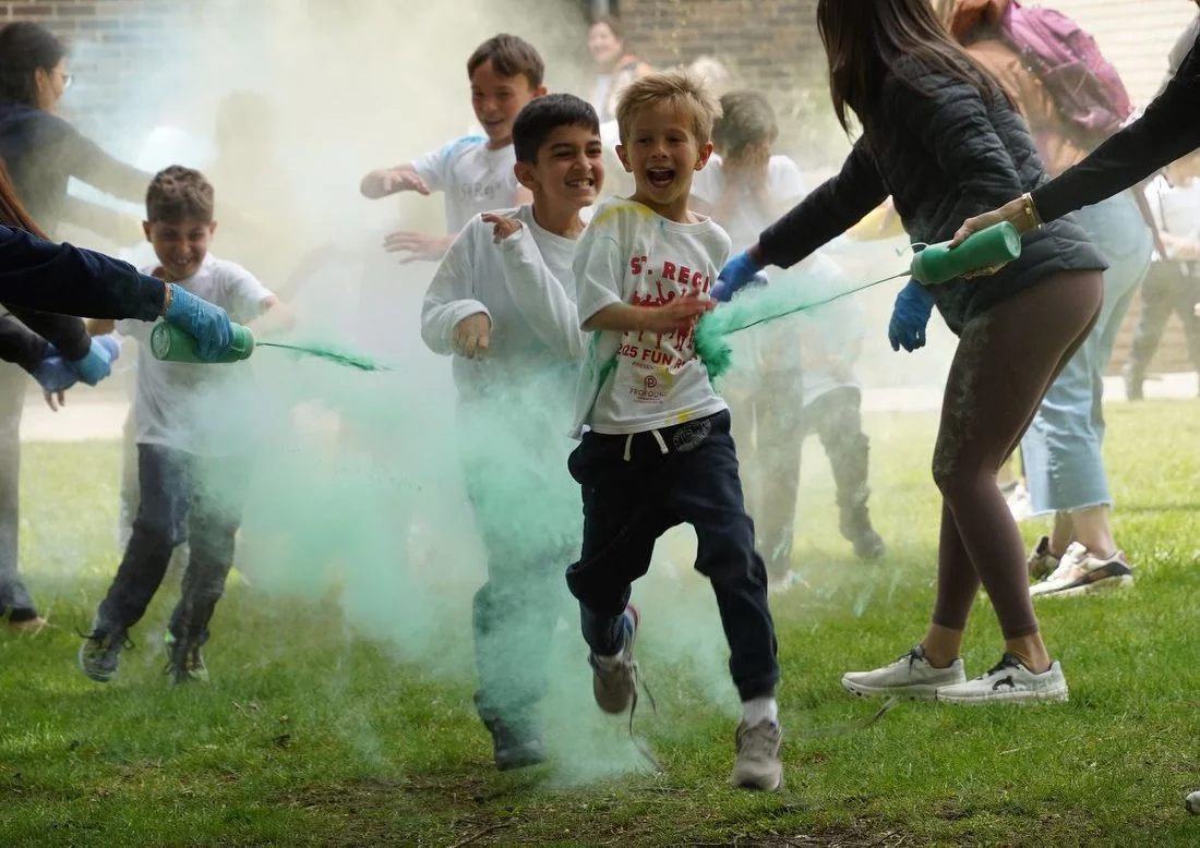 Students running through colored powder at a color run