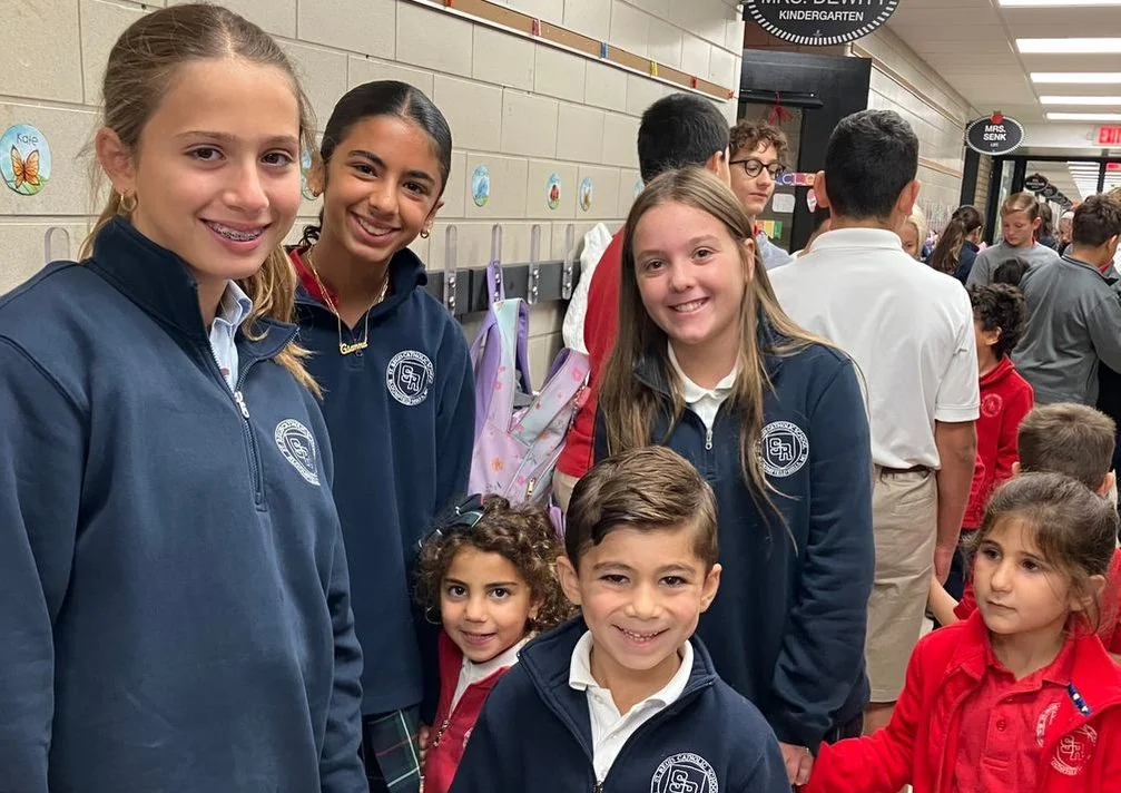 Older and younger students together in the school hallway