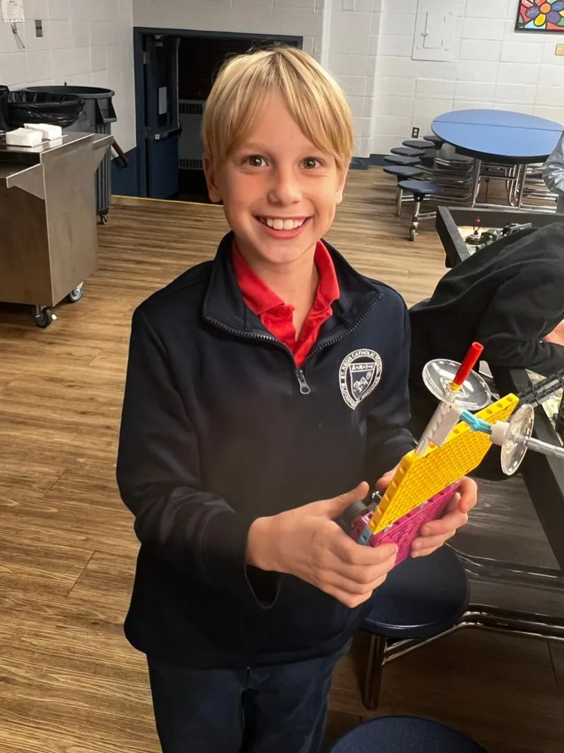 Student holding a project he built