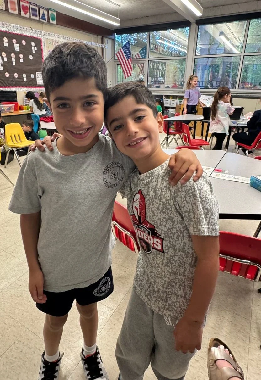 Two students smiling in their classroom