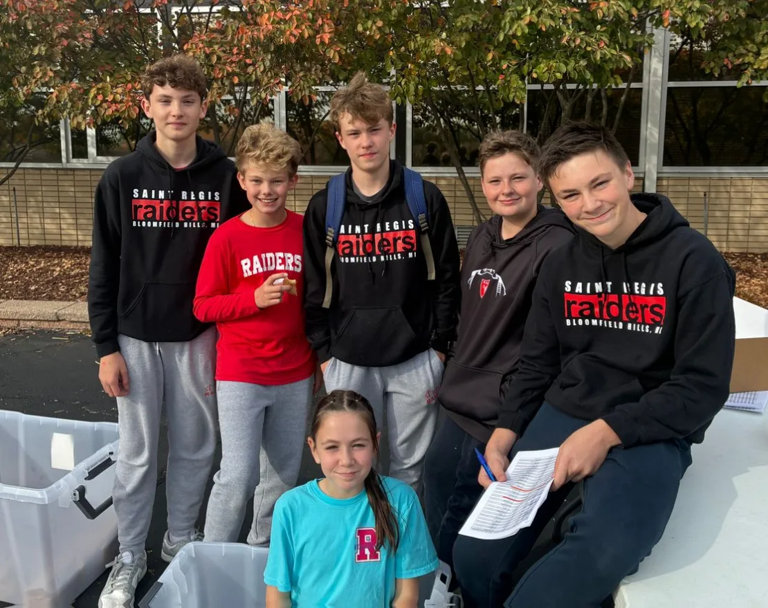 Academy students in St. Regis Raiders sweatshirts outdoors