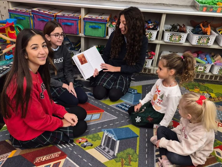 Older students reading to preschool students