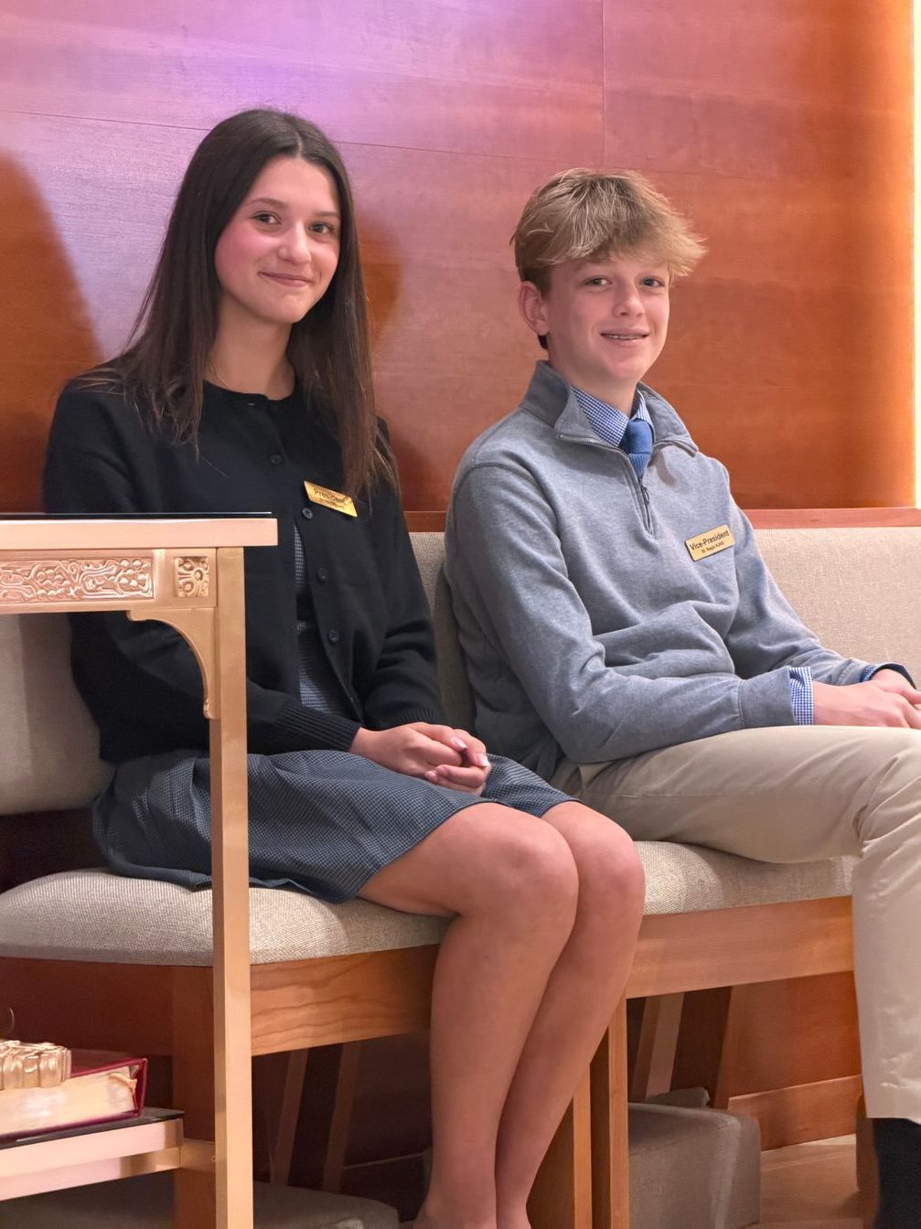 Two students sitting together in church