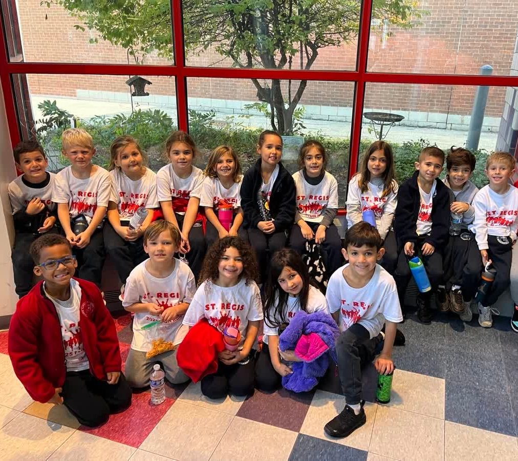 Students in St. Regis T-shirts sitting together