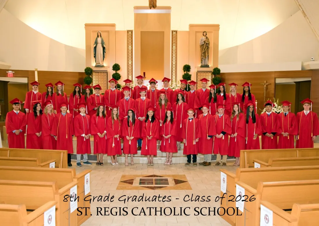 St. Regis Catholic School 8th grade graduates, Class of 2026, in red caps and gowns in church