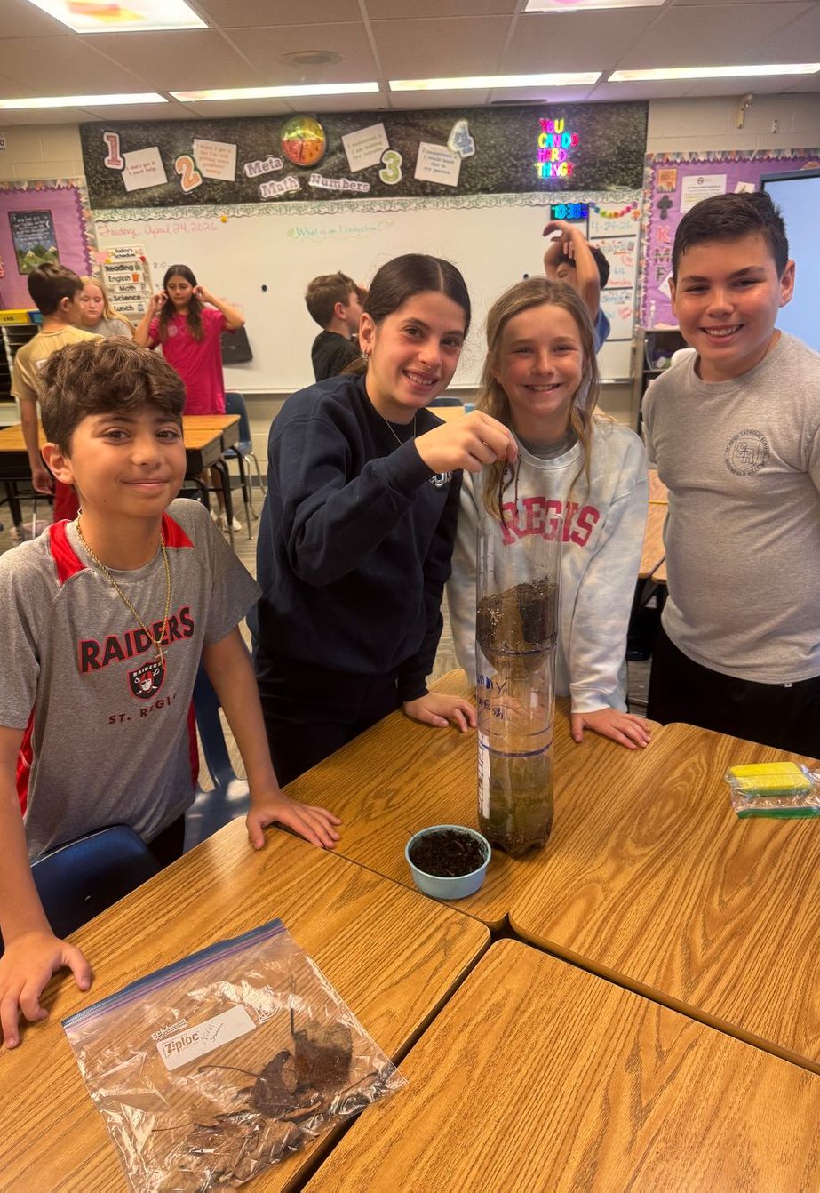 Students and teacher with a classroom science experiment