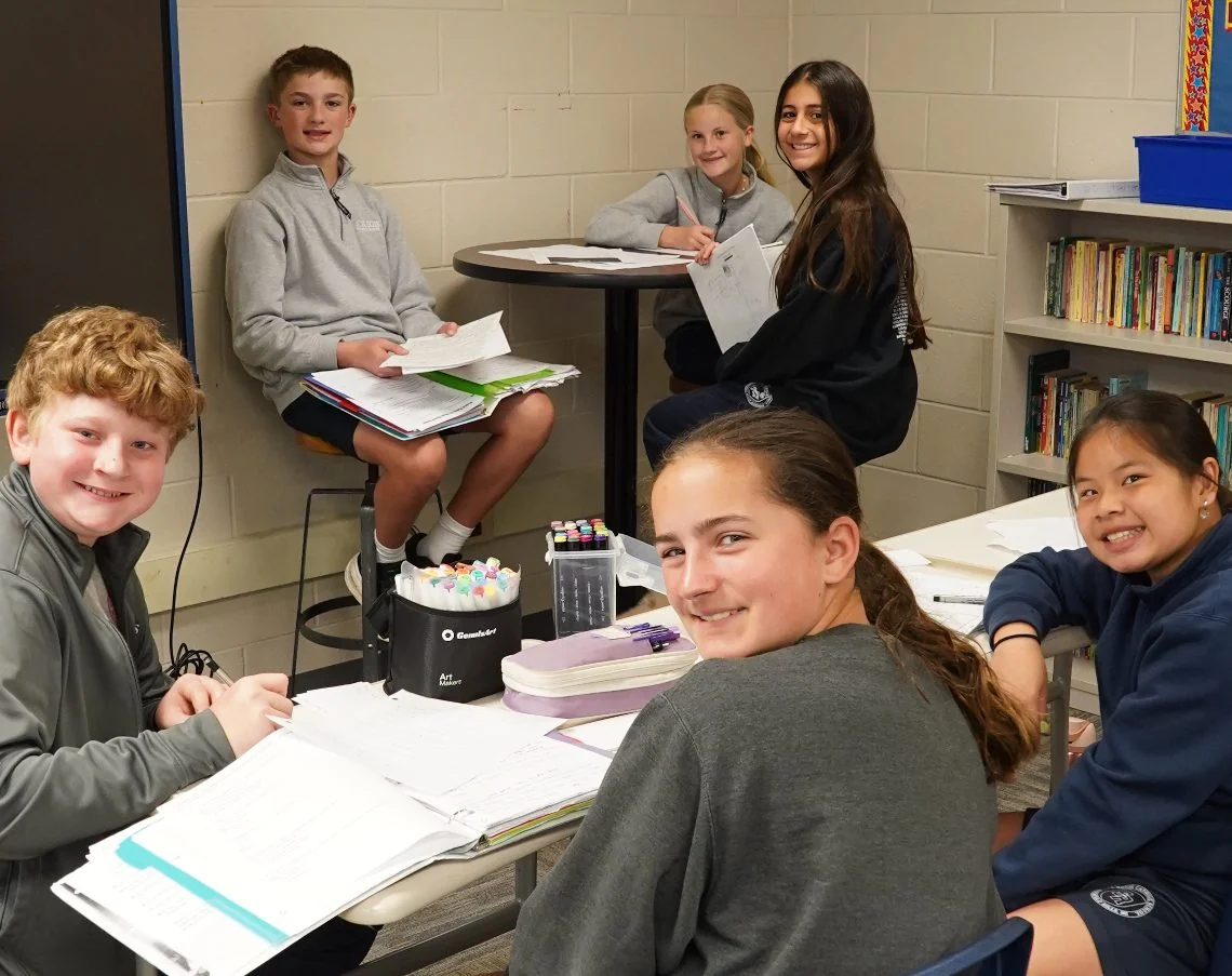 Academy students studying together at a table
