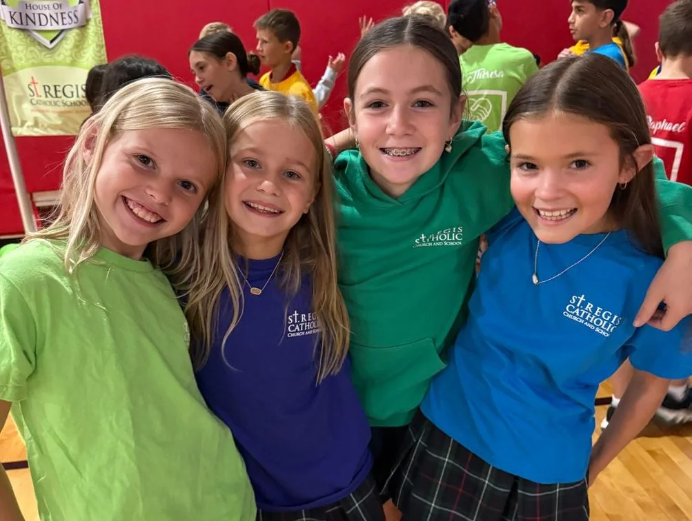 Students in house T-shirts smiling together