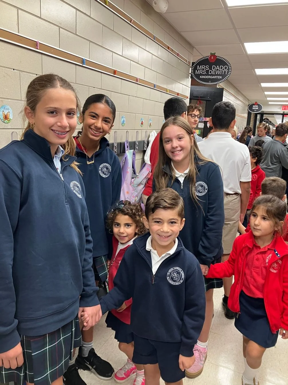 Older and younger students together in the school hallway