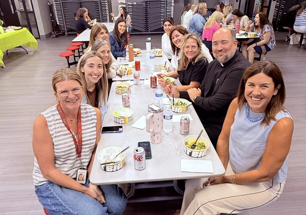 St. Regis faculty and staff sharing a meal in the school lunchroom