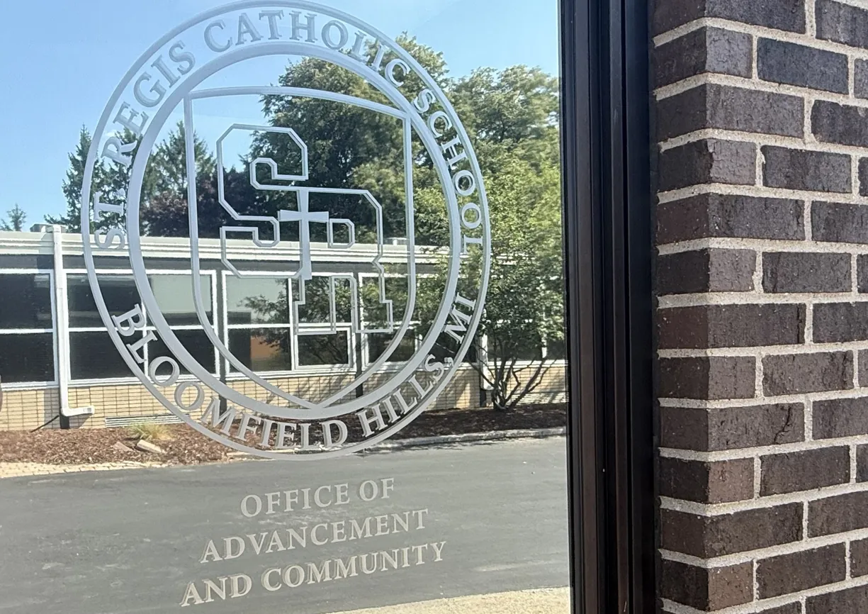 St. Regis Catholic School seal on the Office of Advancement and Community door