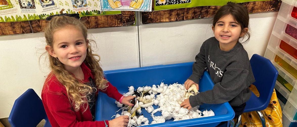 Two preschool students at a sensory table