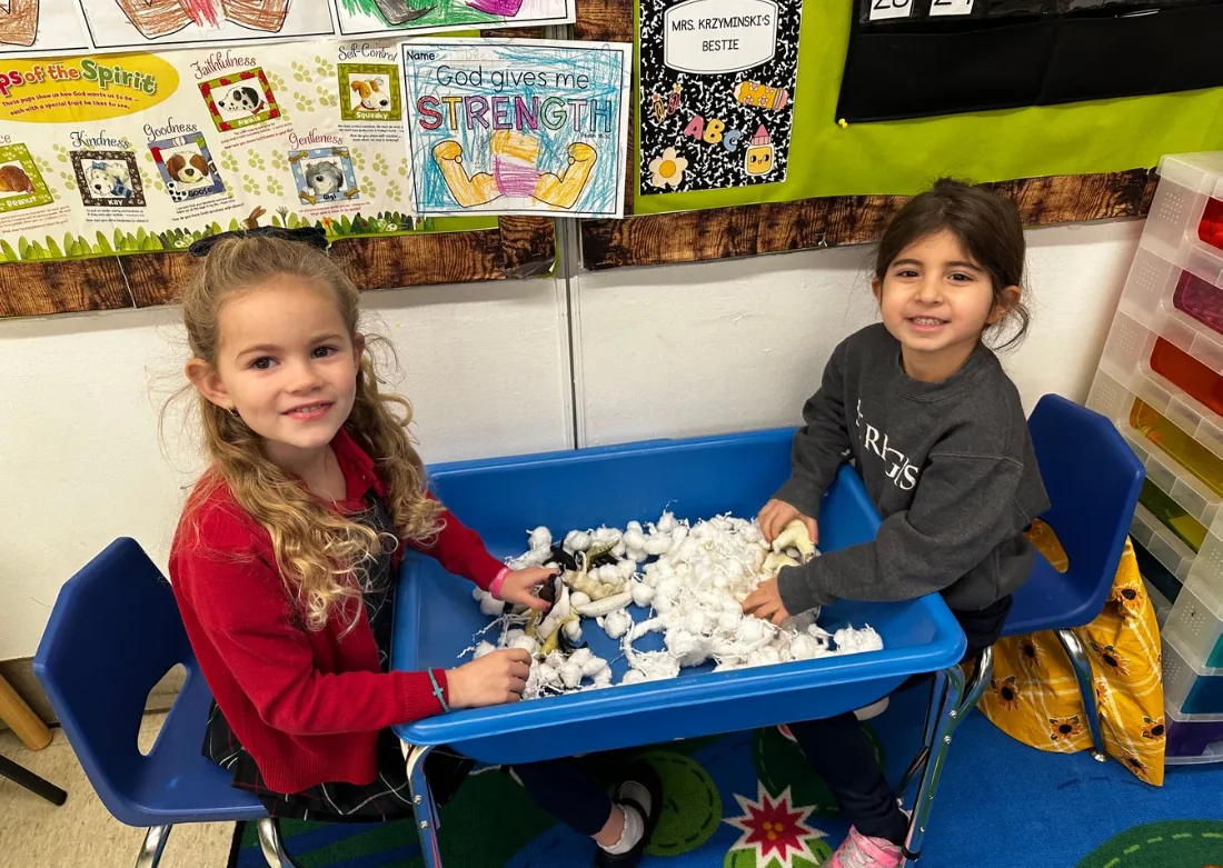 Two preschool students at a sensory table