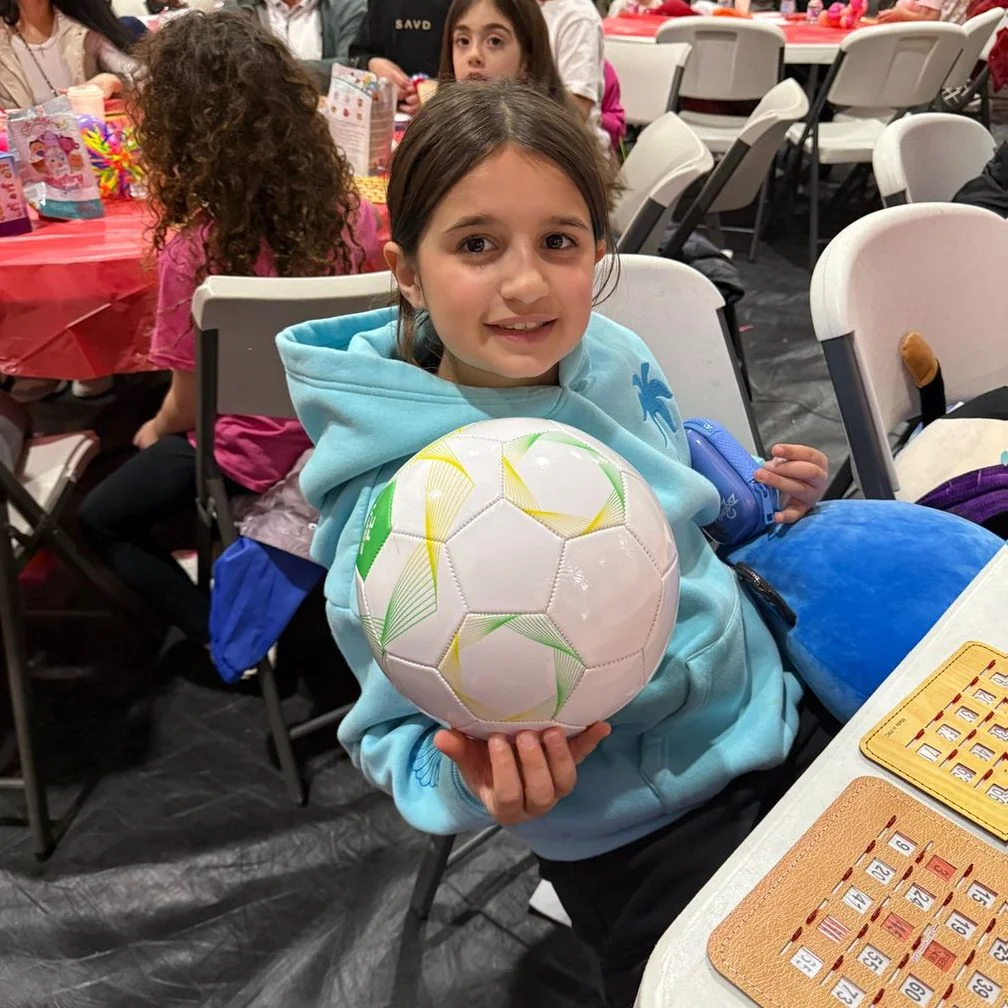 Student holding a ball at a school event