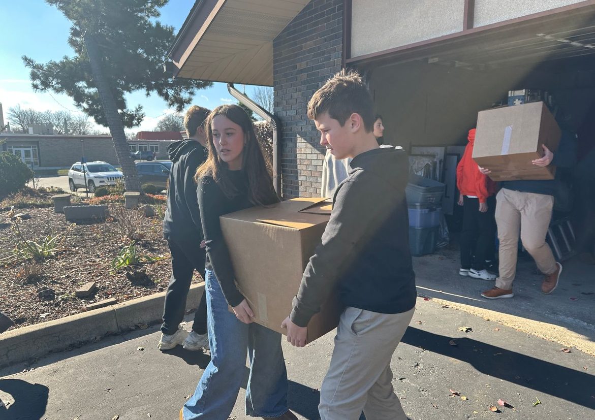 Students carrying donation boxes