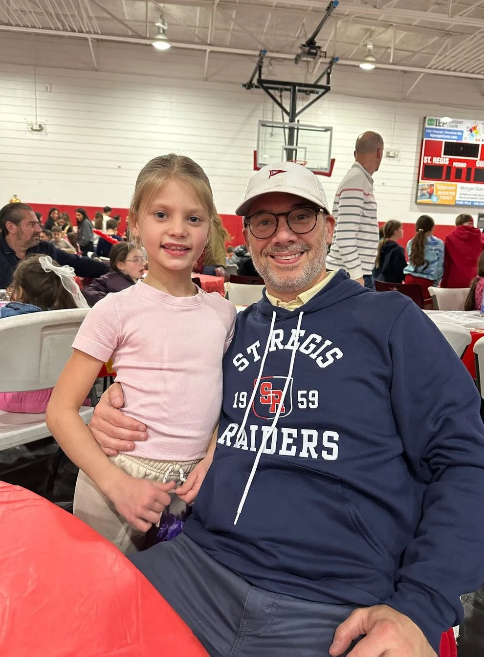 Student and her father at a school event in the gym
