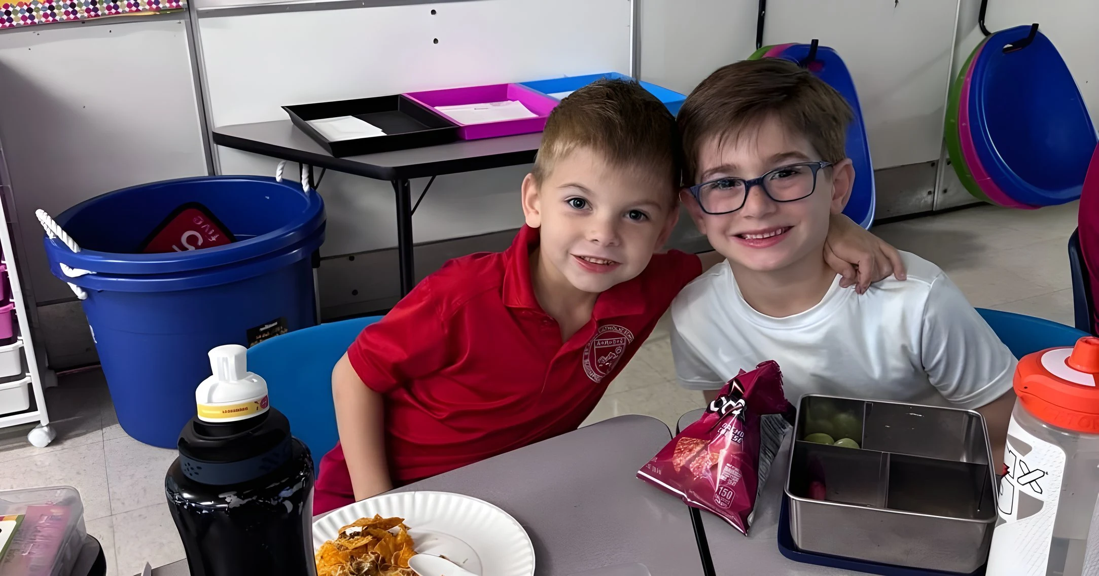 Two students smiling at lunch