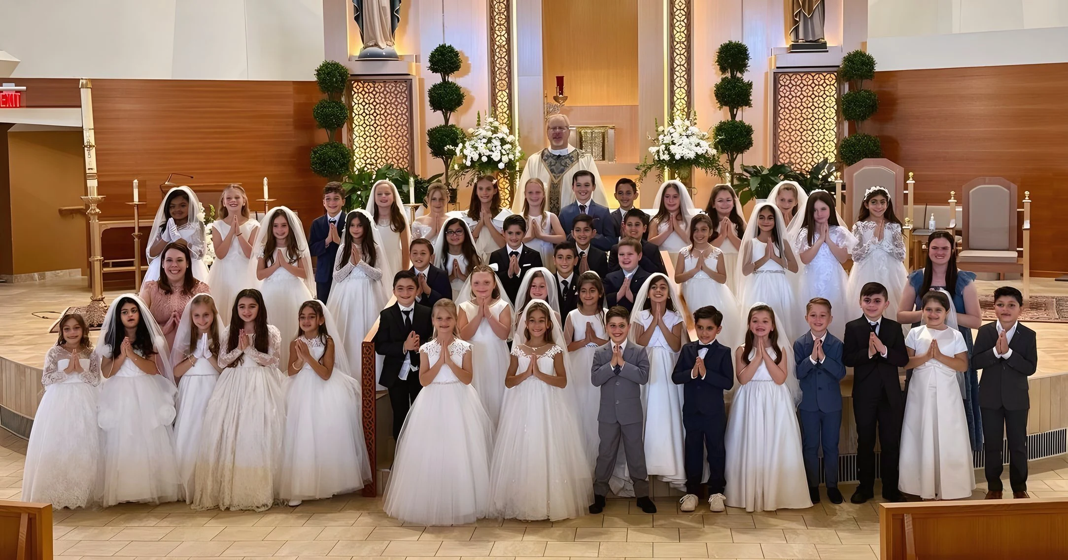 First Communion class at the altar of St. Regis Church