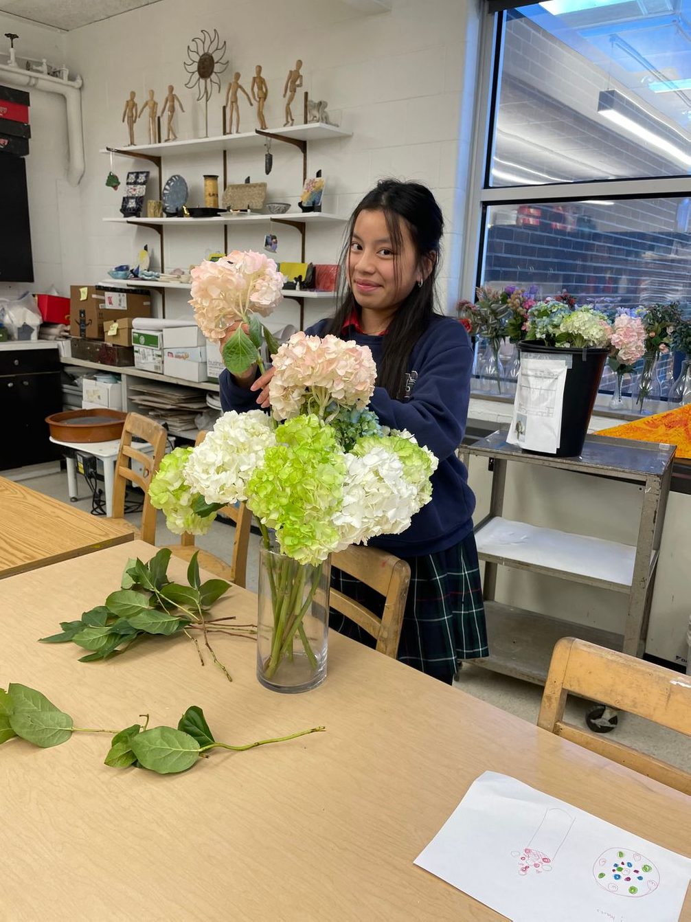 Student arranging flowers in a vase